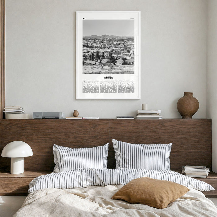 Abuja Newspaper Poster in a white wood frame, hanging in a bedroom