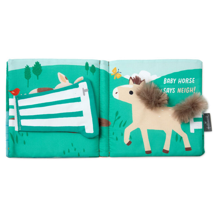 Farm-themed touch-and-feel baby book with soft fabric pages featuring baby duck, pig, horse, and cow illustrations.