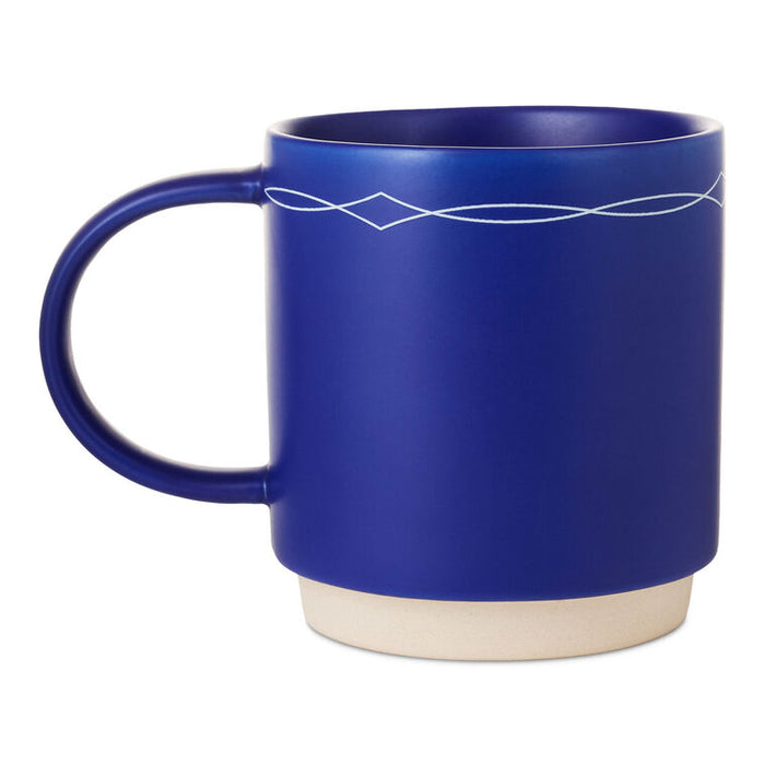 Cobalt blue ceramic mug with white text that reads “This ain't my first rodeo” and a cowboy boots design, stackable base.