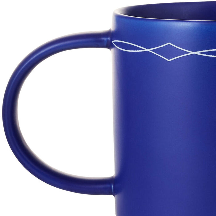 Cobalt blue ceramic mug with white text that reads “This ain't my first rodeo” and a cowboy boots design, stackable base.